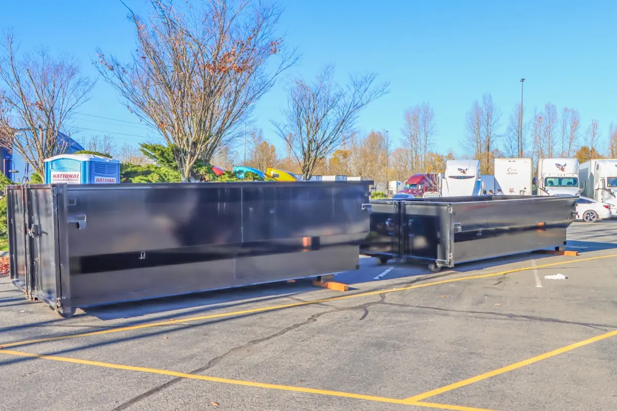 Professional dumpster rental service with roll-off container on residential driveway in Carrollwood